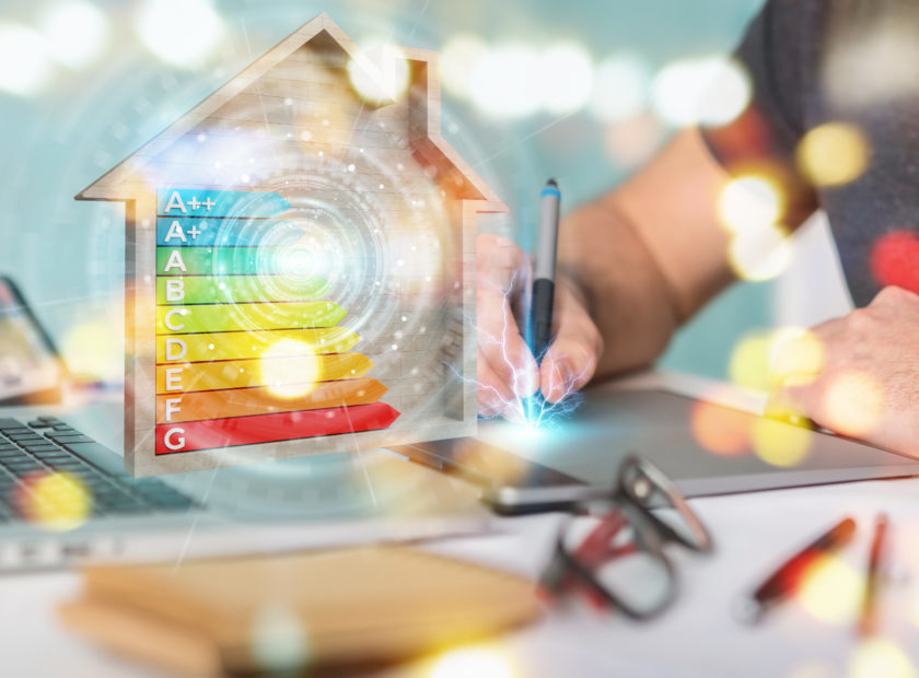 Graphic designer using 3D rendering energy rating chart in a wooden house
